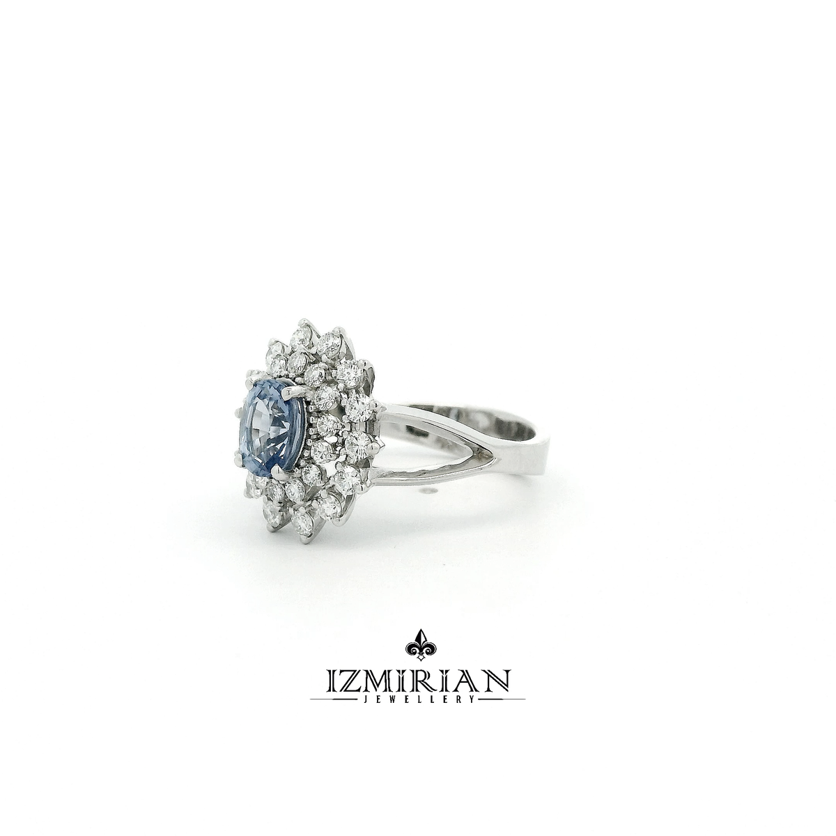 Angled side view of blue sapphire halo ring highlighting diamond setting