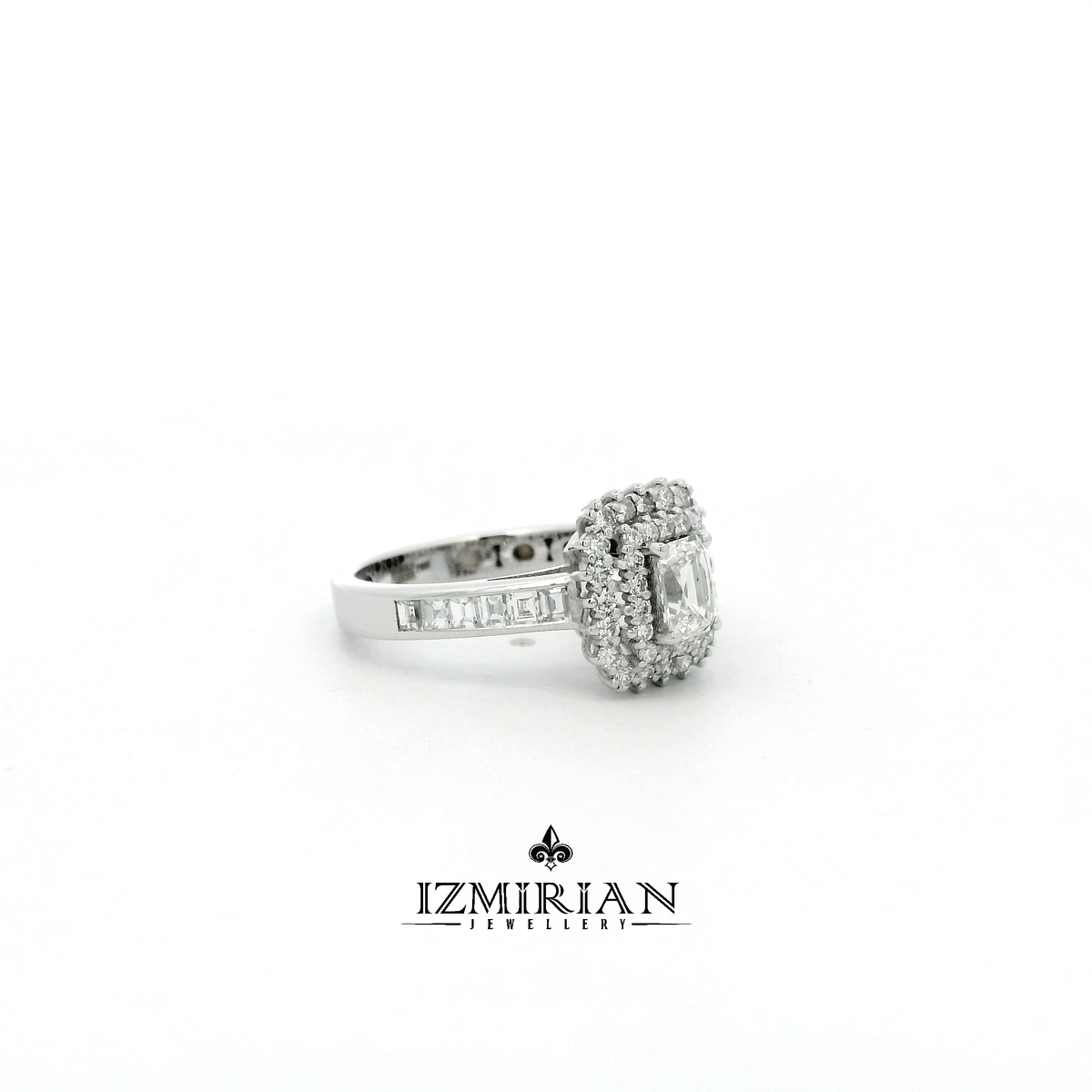 Side view of white gold ring with emerald cut diamond and baguette band