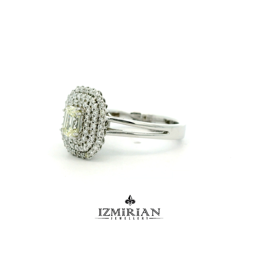Angled view of emerald cut diamond ring with triple halo design