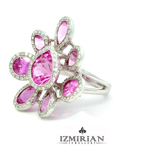 Angled view of pink sapphire flower ring with diamond halo accents