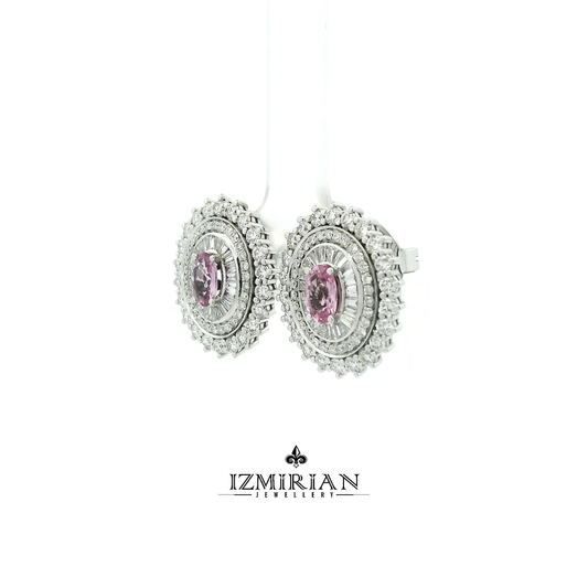 Angled view of oval pink sapphire earrings with layered diamond setting