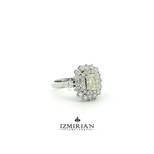 Side view of white gold ring with radiant diamond and multi layer halo