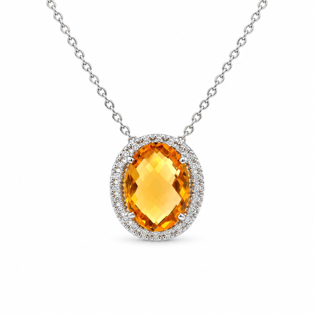 An oval-cut yellow citrine pendant necklace with a halo of small clear stones, suspended from a silver-toned chain on a white background.