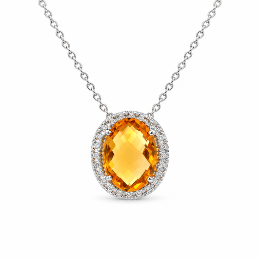 An oval-cut yellow citrine pendant necklace with a halo of small clear stones, suspended from a silver-toned chain on a white background.