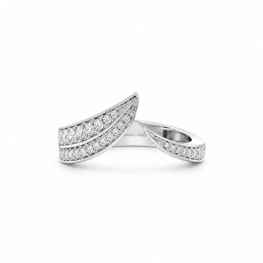 A silver-toned wrap ring featuring pavé-set clear stones along two curved leaf-like bands, shown on a clean white background.