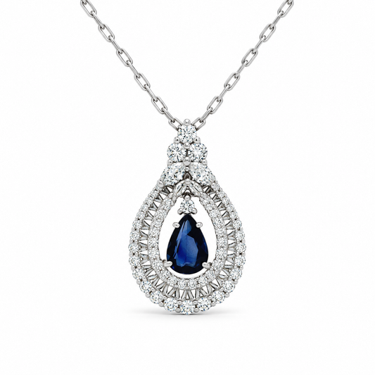 A pear-cut blue sapphire pendant necklace set in a silver-toned diamond halo and chain, shown against a plain white background.
