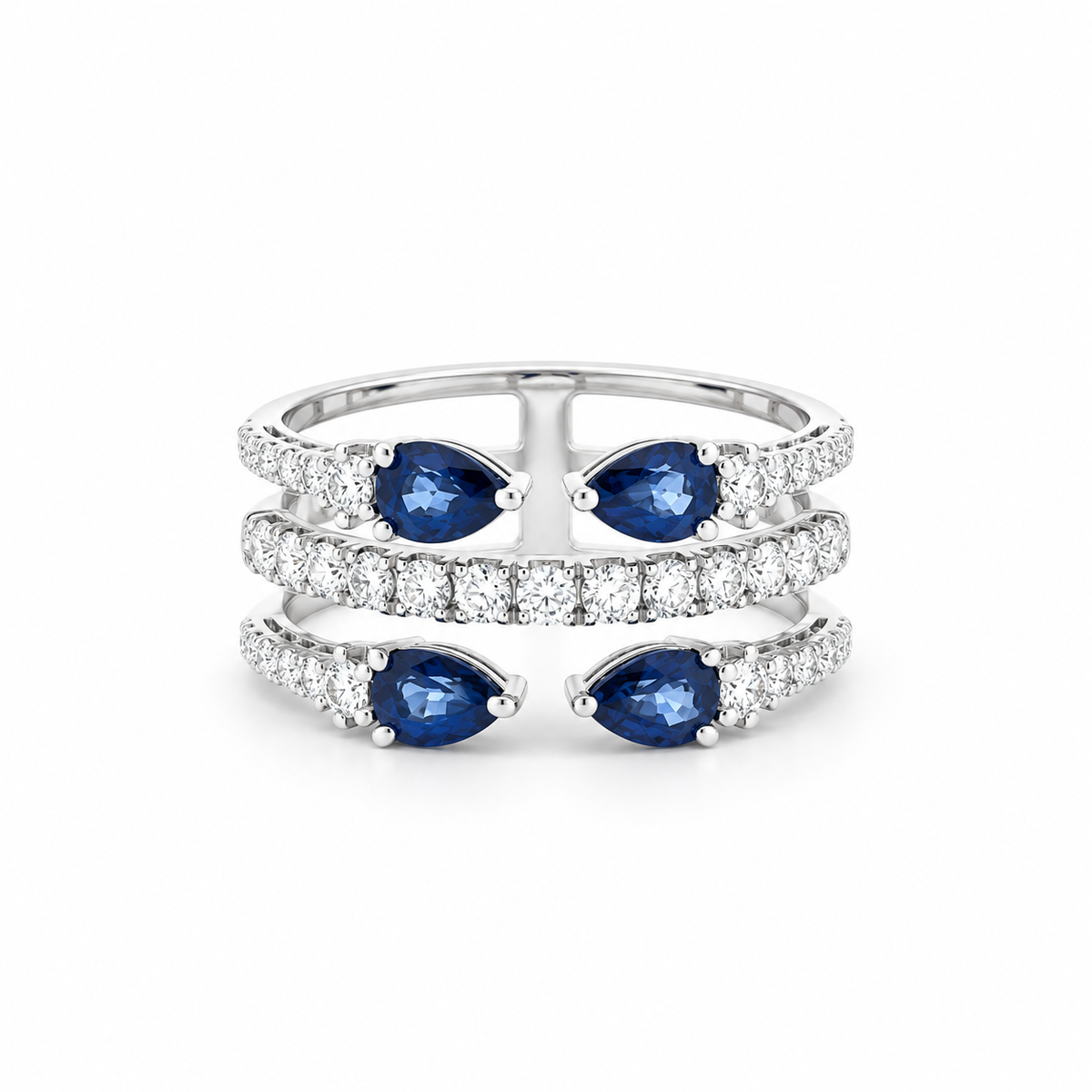 A silver-tone triple-band ring featuring three rows of pavé-set round diamonds, with three pairs of marquise-cut blue sapphires set on the outer bands.