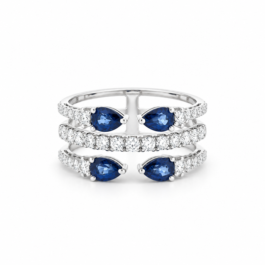 A silver-tone triple-band ring featuring three rows of pavé-set round diamonds, with three pairs of marquise-cut blue sapphires set on the outer bands.