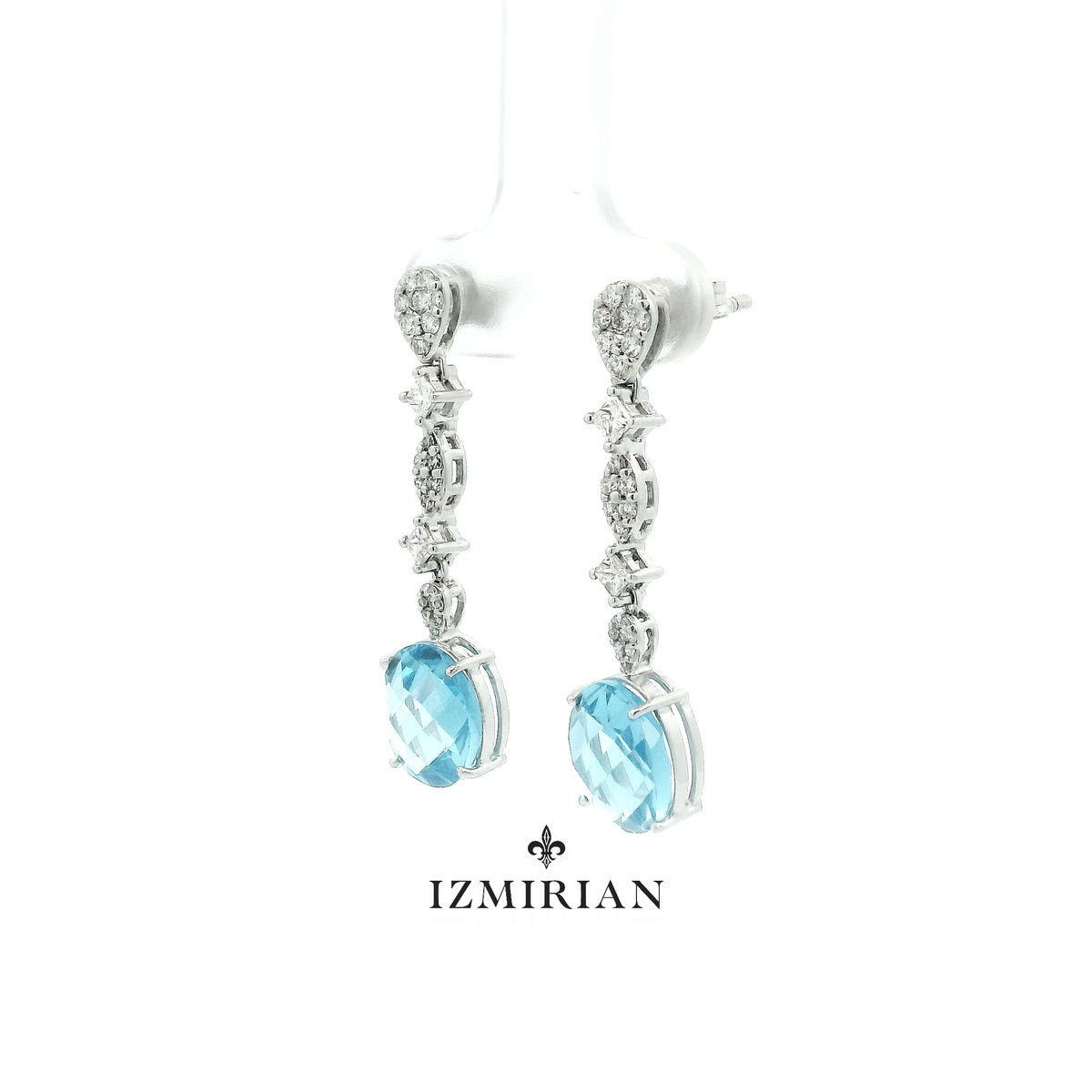 Angled view of white gold aquamarine and diamond drop earrings