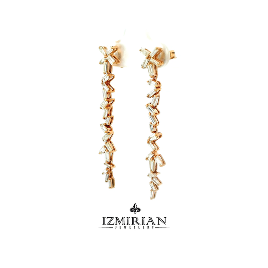 Angled view of rose gold baguette diamond drop earrings