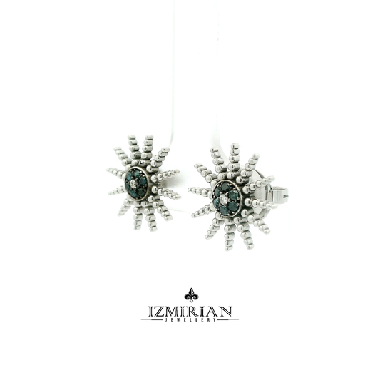 Angled view of white gold stud with blue diamond cluster and beaded design