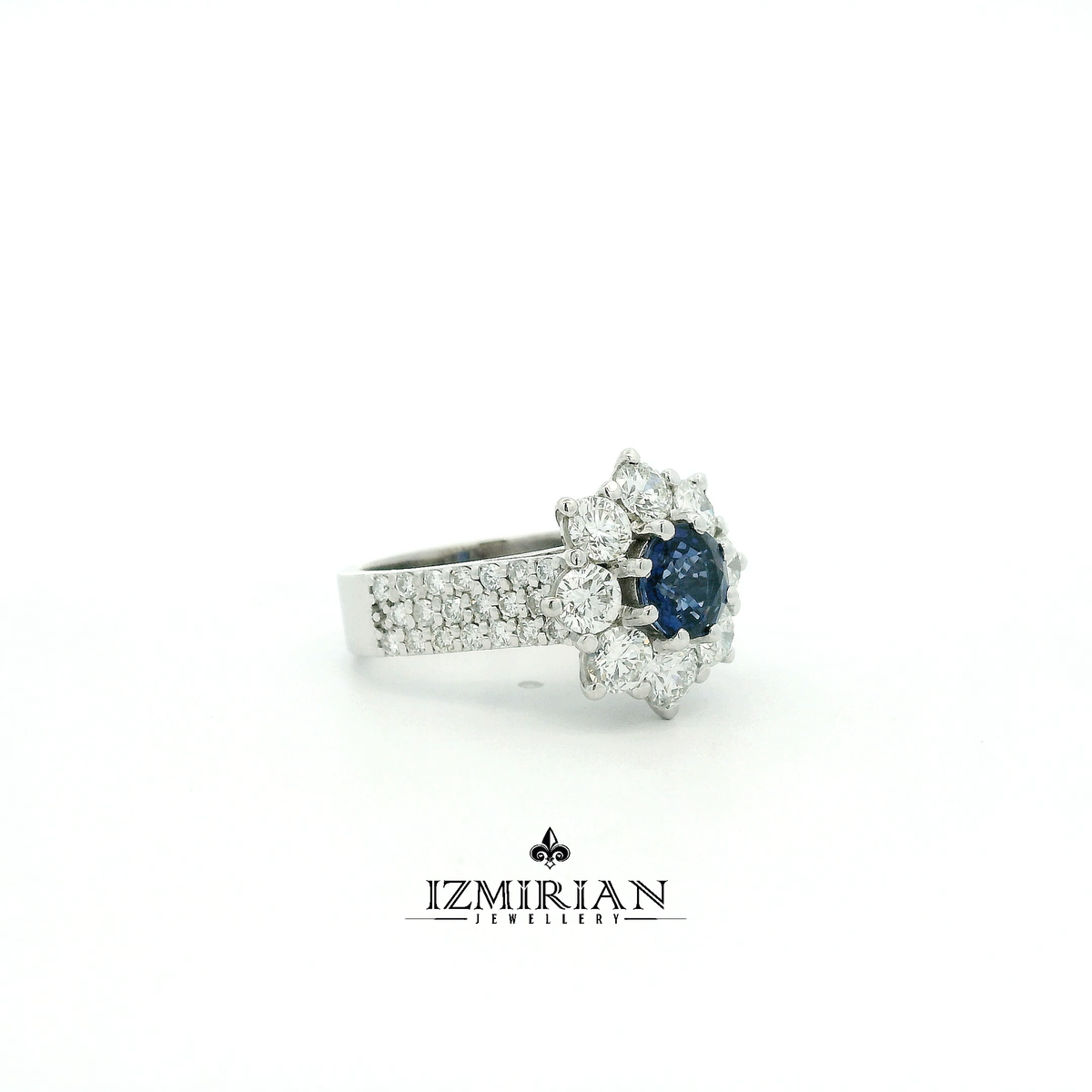 Side view of white gold ring with blue sapphire and diamond-set band