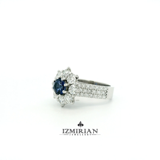 Angled view of blue sapphire ring with round diamond cluster setting