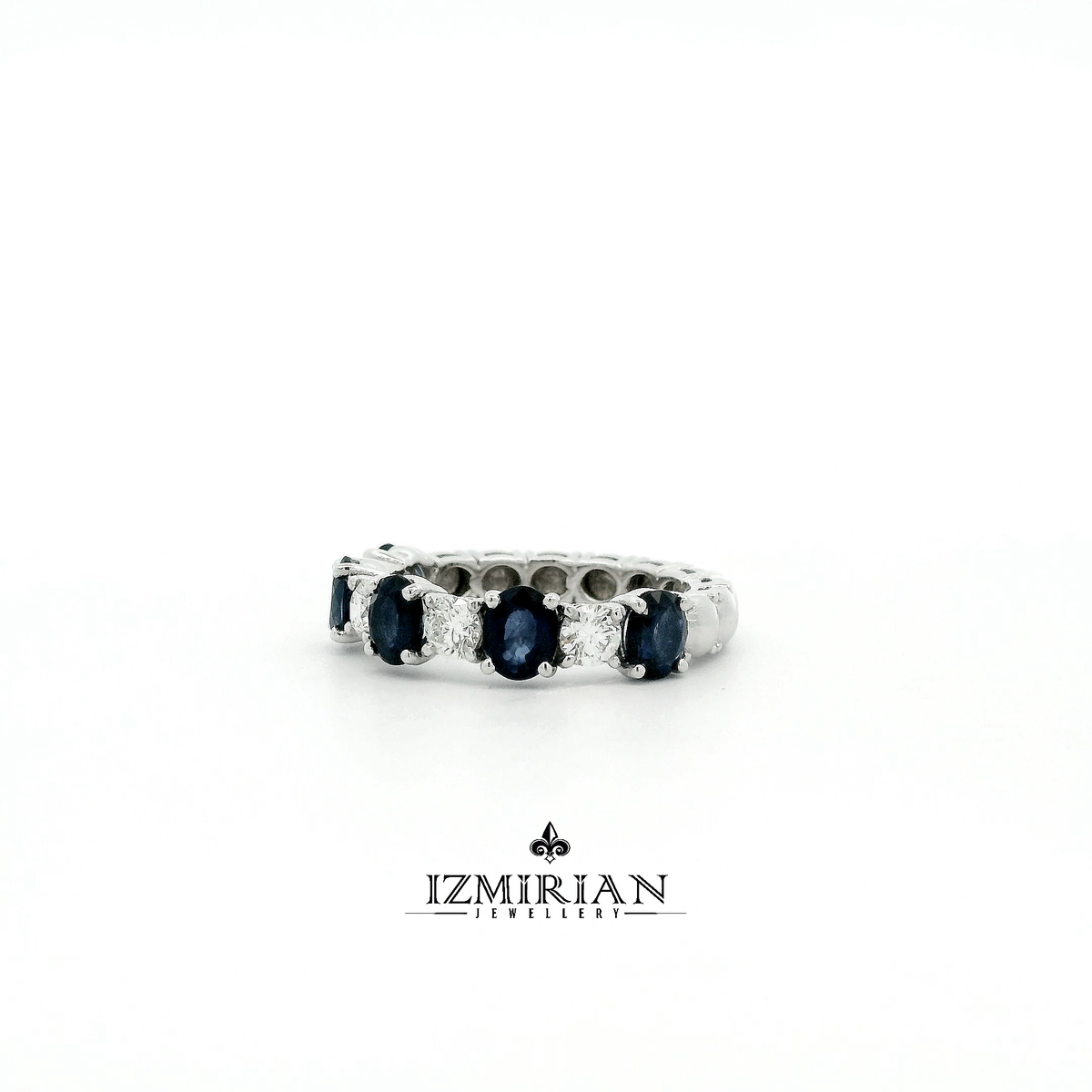 Angled view of sapphire and diamond eternity band in white gold
