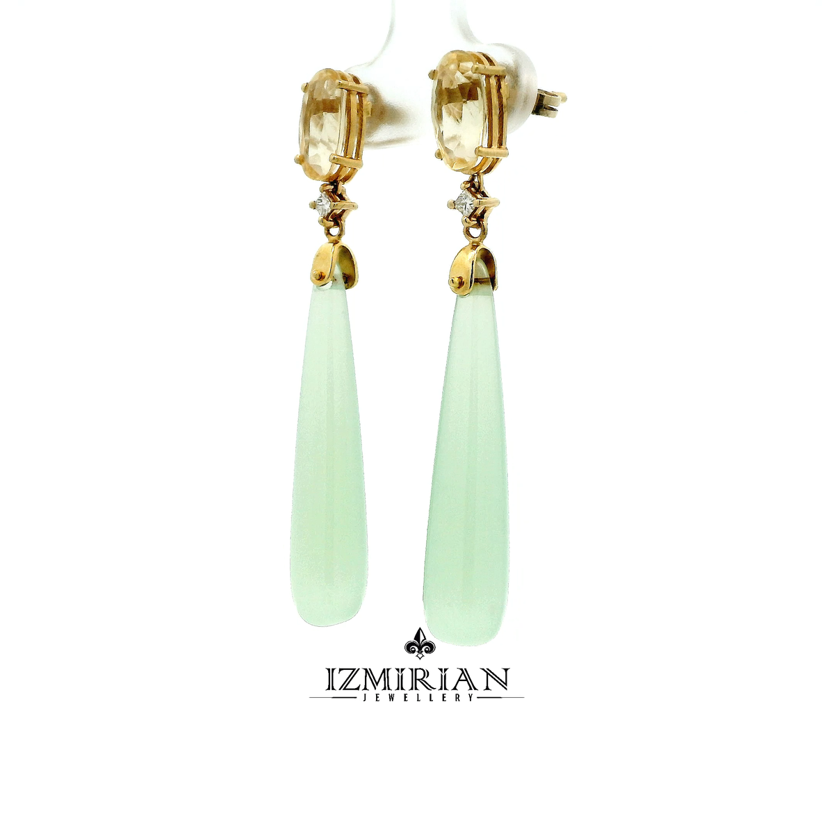 Angled view of citrine stud and jade drop earrings in yellow gold