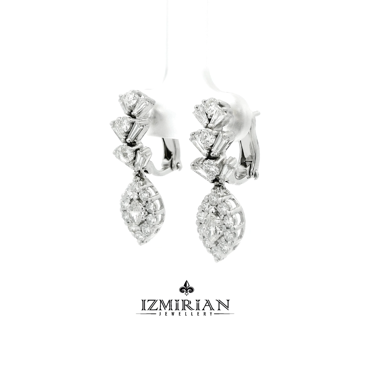 Angled view of diamond drop earrings with baguette and pear clusters