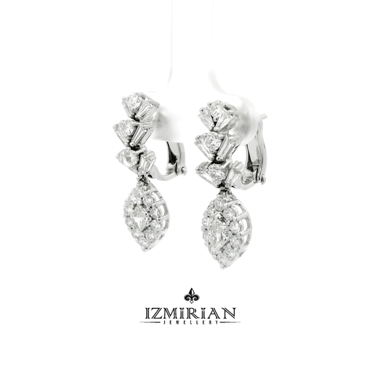 Angled view of diamond drop earrings with baguette and pear clusters