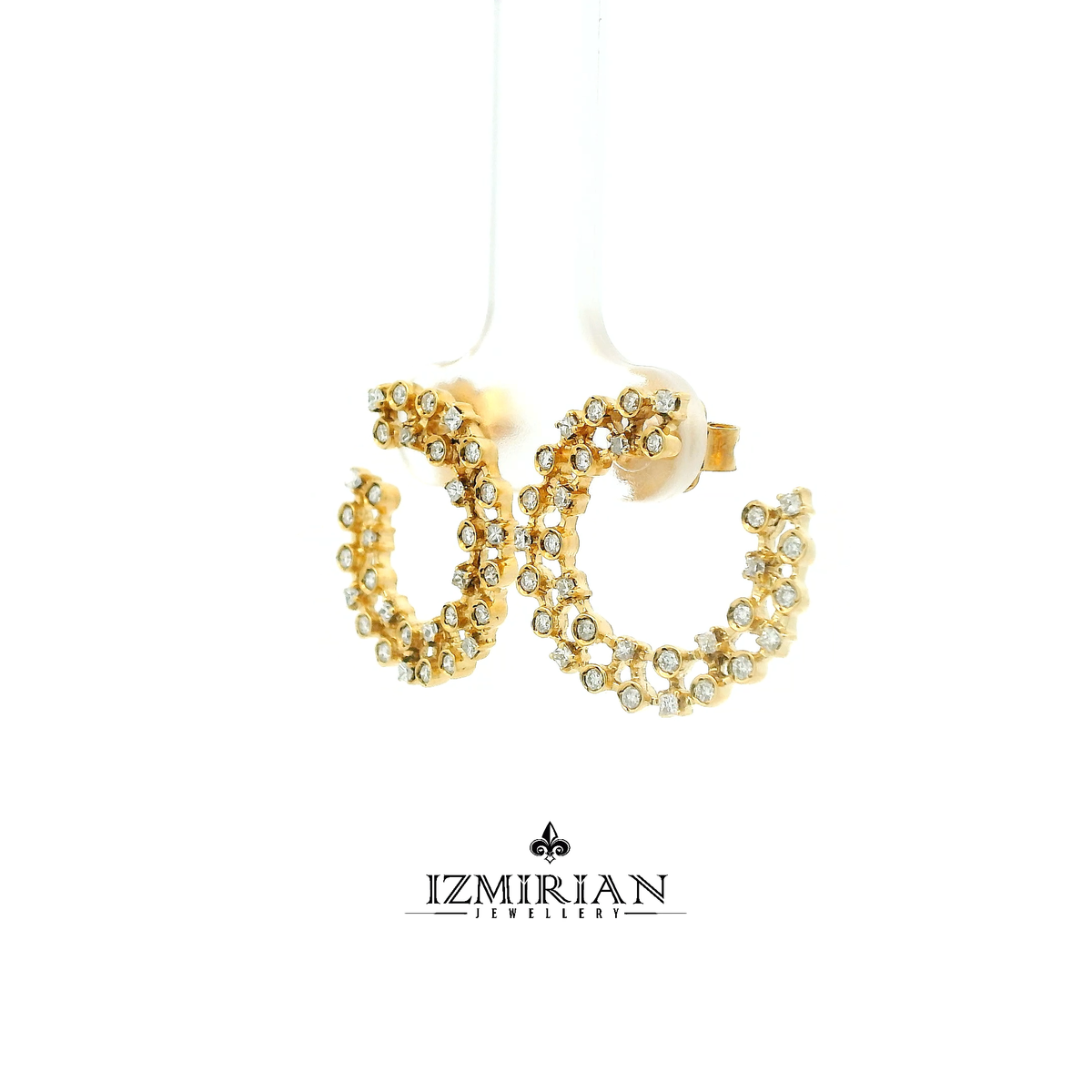 Angled view of diamond lattice hoop earrings in yellow gold