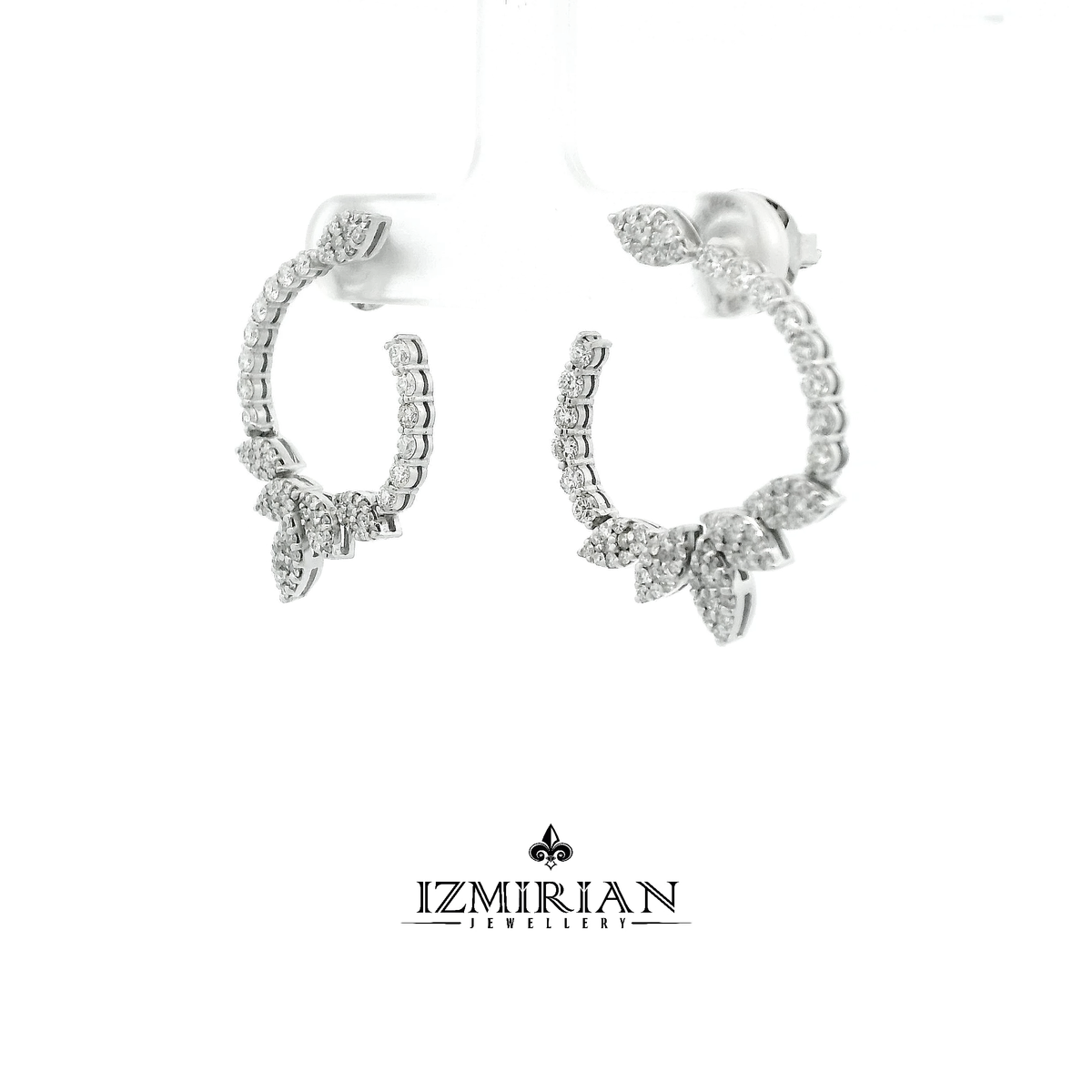 Angled view of diamond leaf hoop earrings in white gold