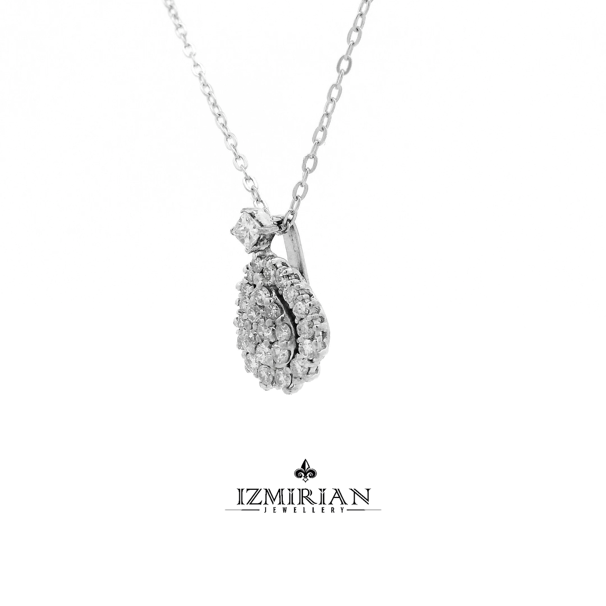 Angled view of diamond teardrop pendant with full cluster design