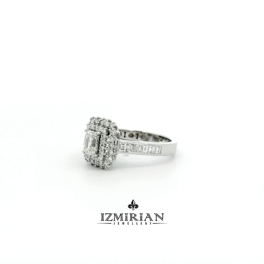 Angled view of emerald cut diamond ring with halo and baguette shoulders