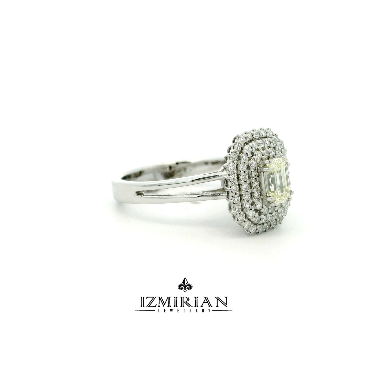 Side view of white gold ring with emerald cut diamond and layered halos