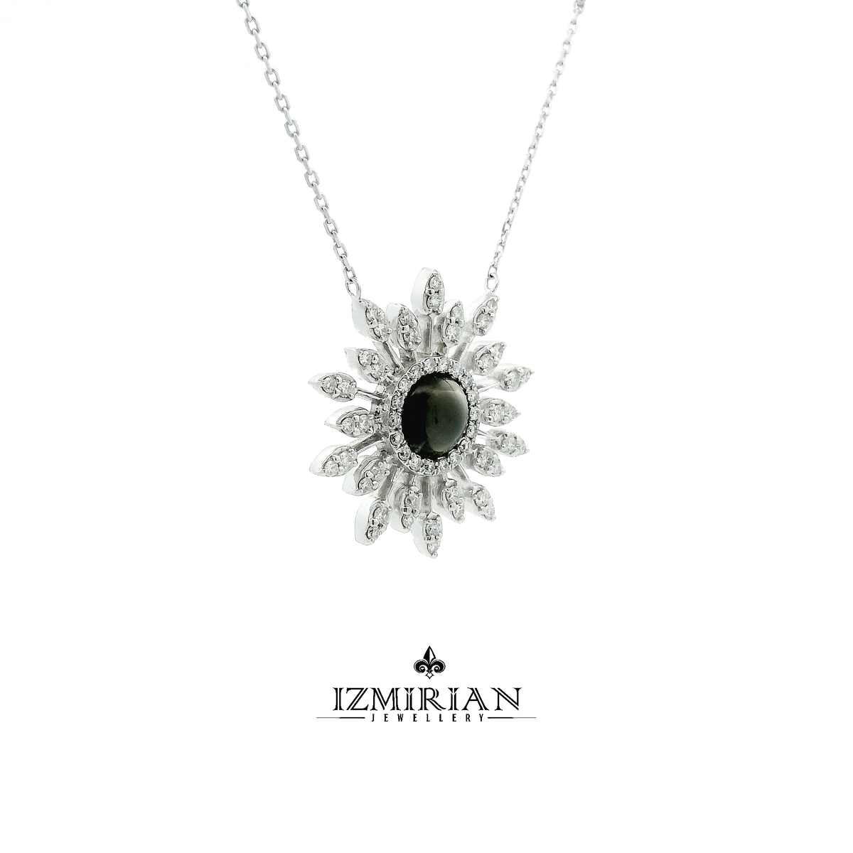 Side view of white gold sunburst pendant with grey gemstone and diamonds