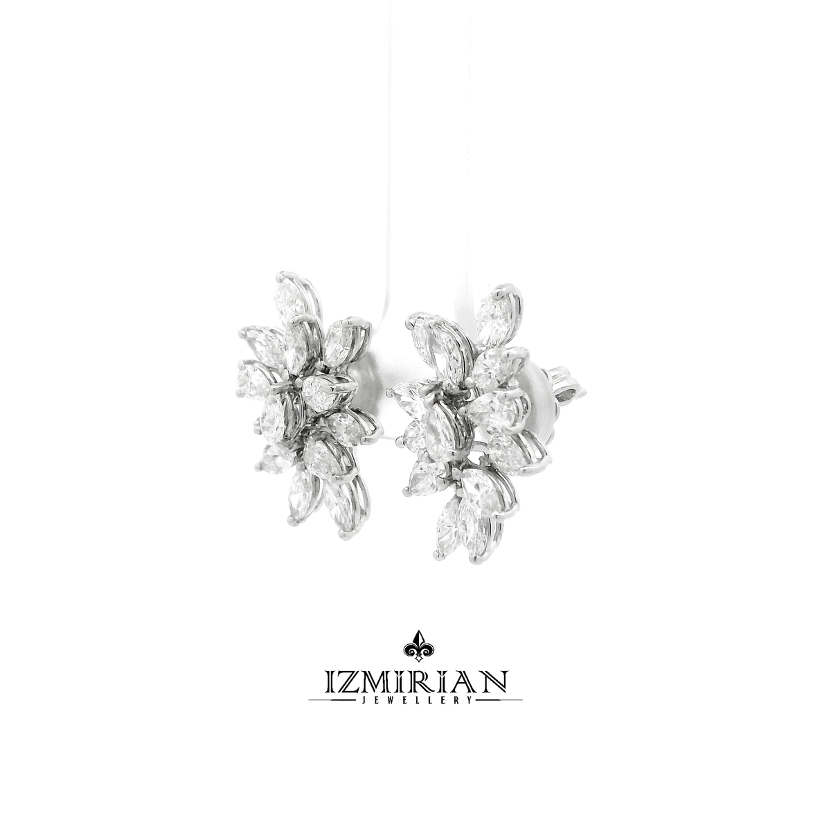 Angled view of marquise diamond cluster earrings in white gold