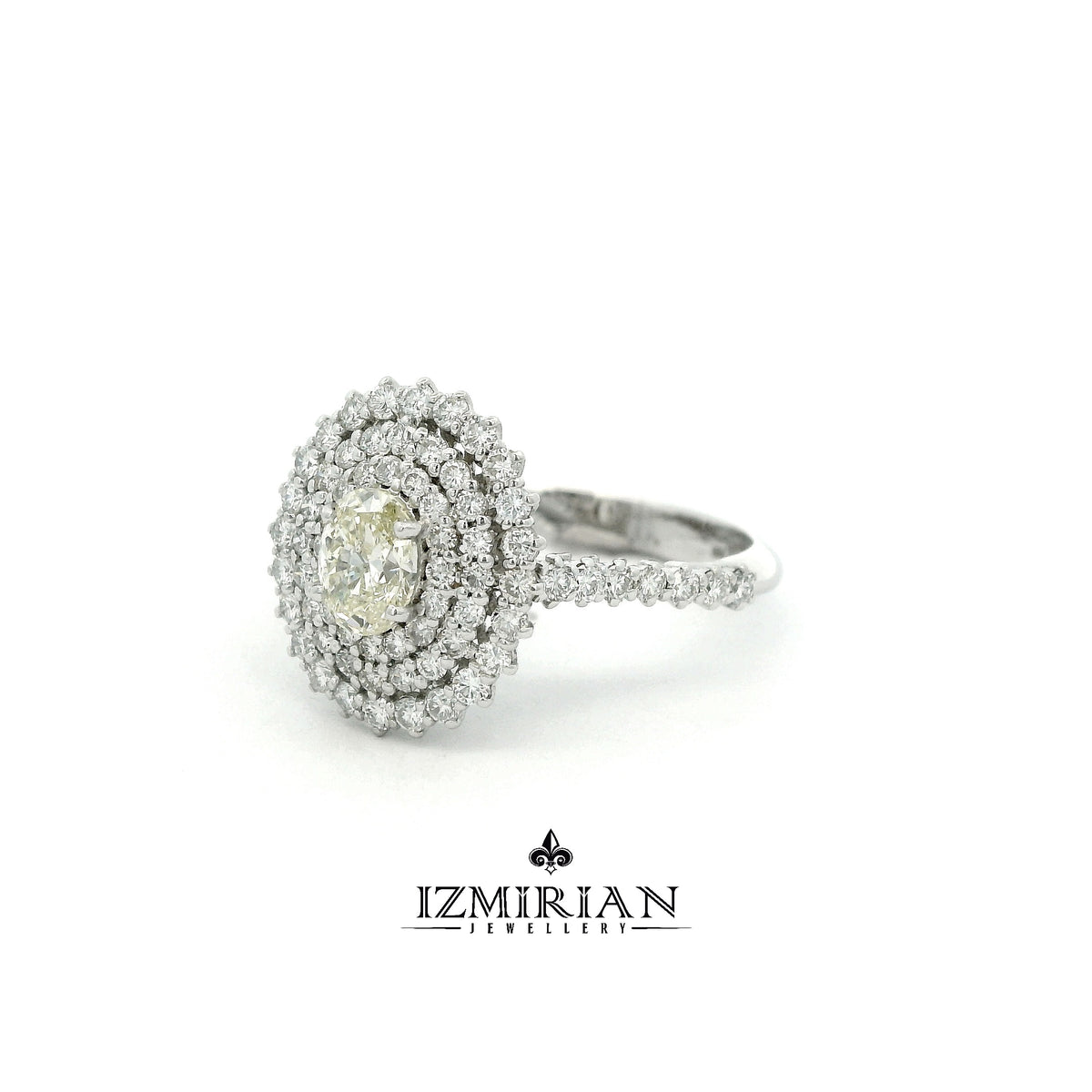 Angled view of oval diamond ring with triple halo design