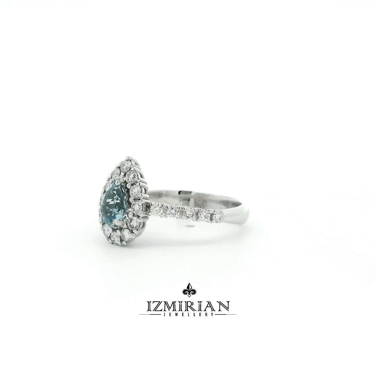 Angled view of aquamarine halo ring with pavé diamond band