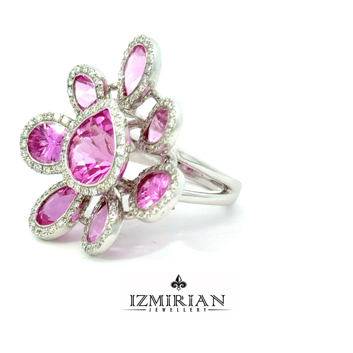 Angled view of pink sapphire flower ring with diamond halo accents