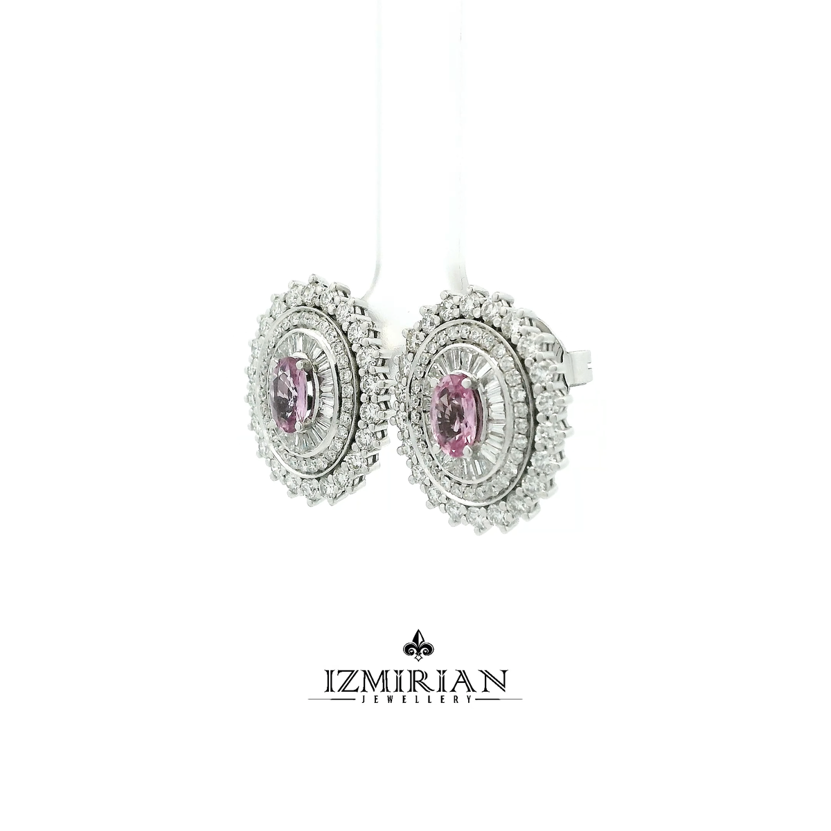 Angled view of oval pink sapphire earrings with layered diamond setting