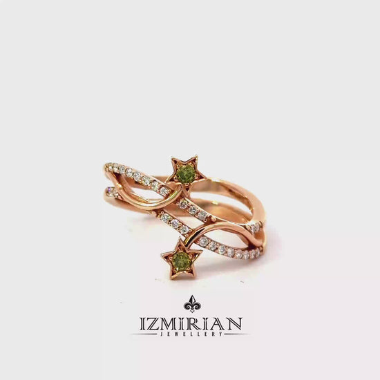 Rose gold star motif diamond ring with green gemstones shown in motion