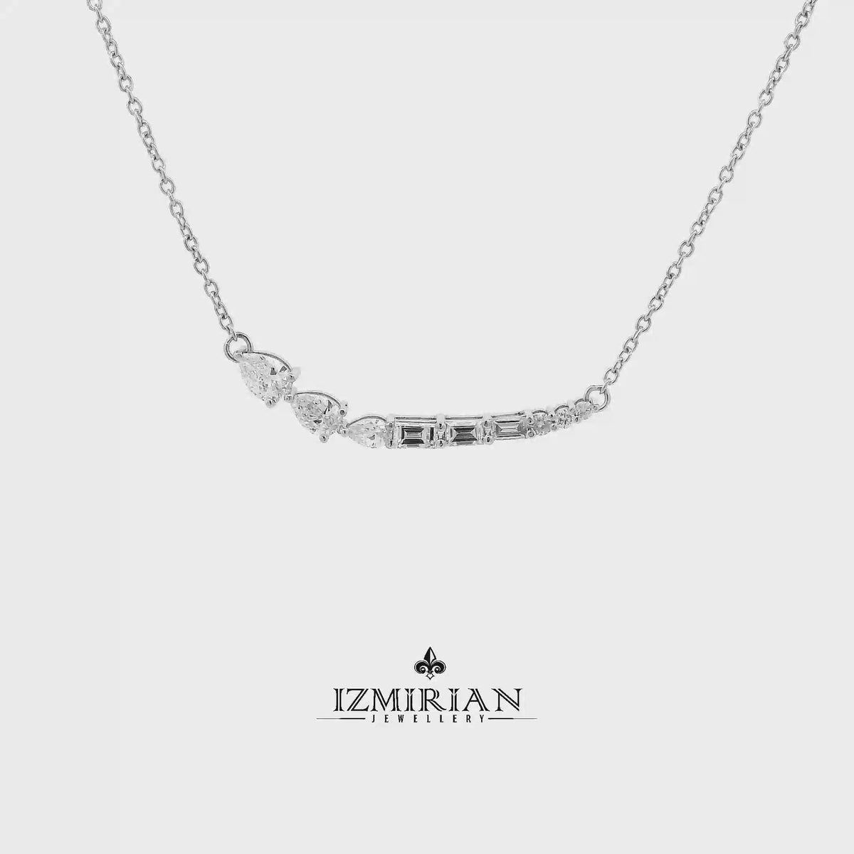 Mixed cut diamond curve necklace in white gold shown in motion
