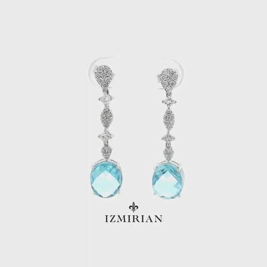 Aquamarine diamond drop earrings in white gold shown in motion