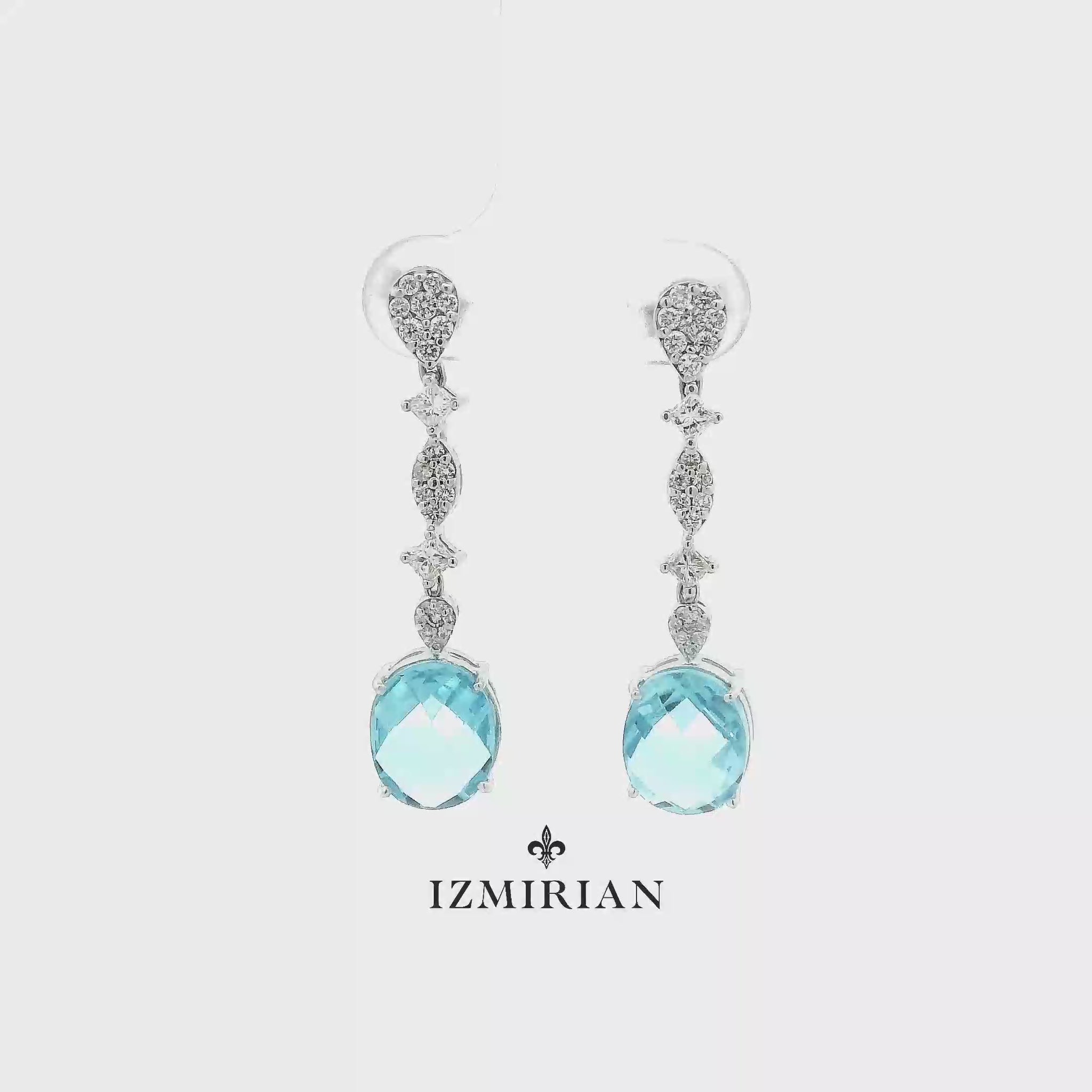 Aquamarine diamond drop earrings in white gold shown in motion