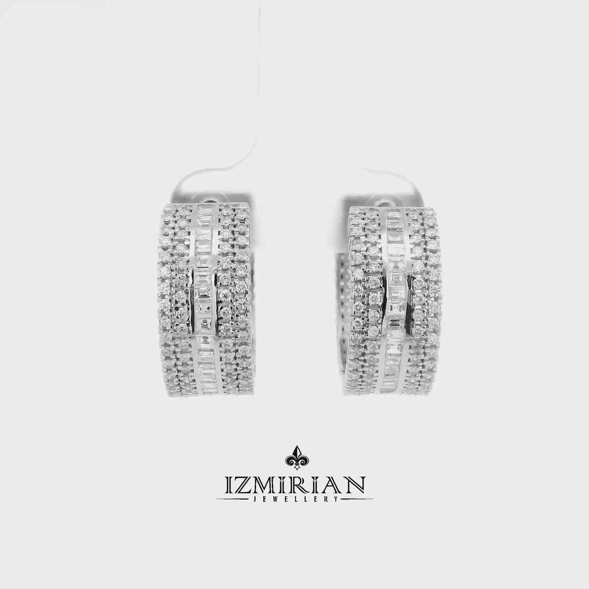 Baguette and pavé diamond huggie earrings in white gold shown in motion