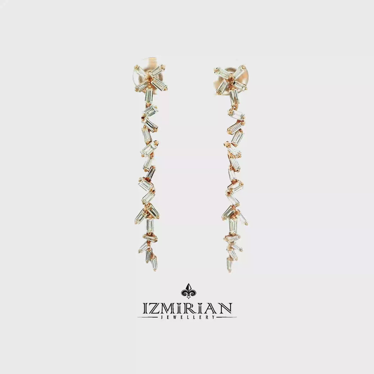 Baguette diamond line drop earrings in rose gold shown in motion
