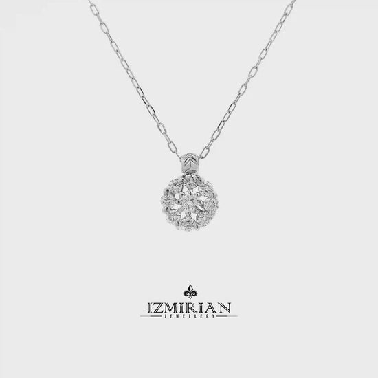 Diamond cluster pendant in white gold shown in motion