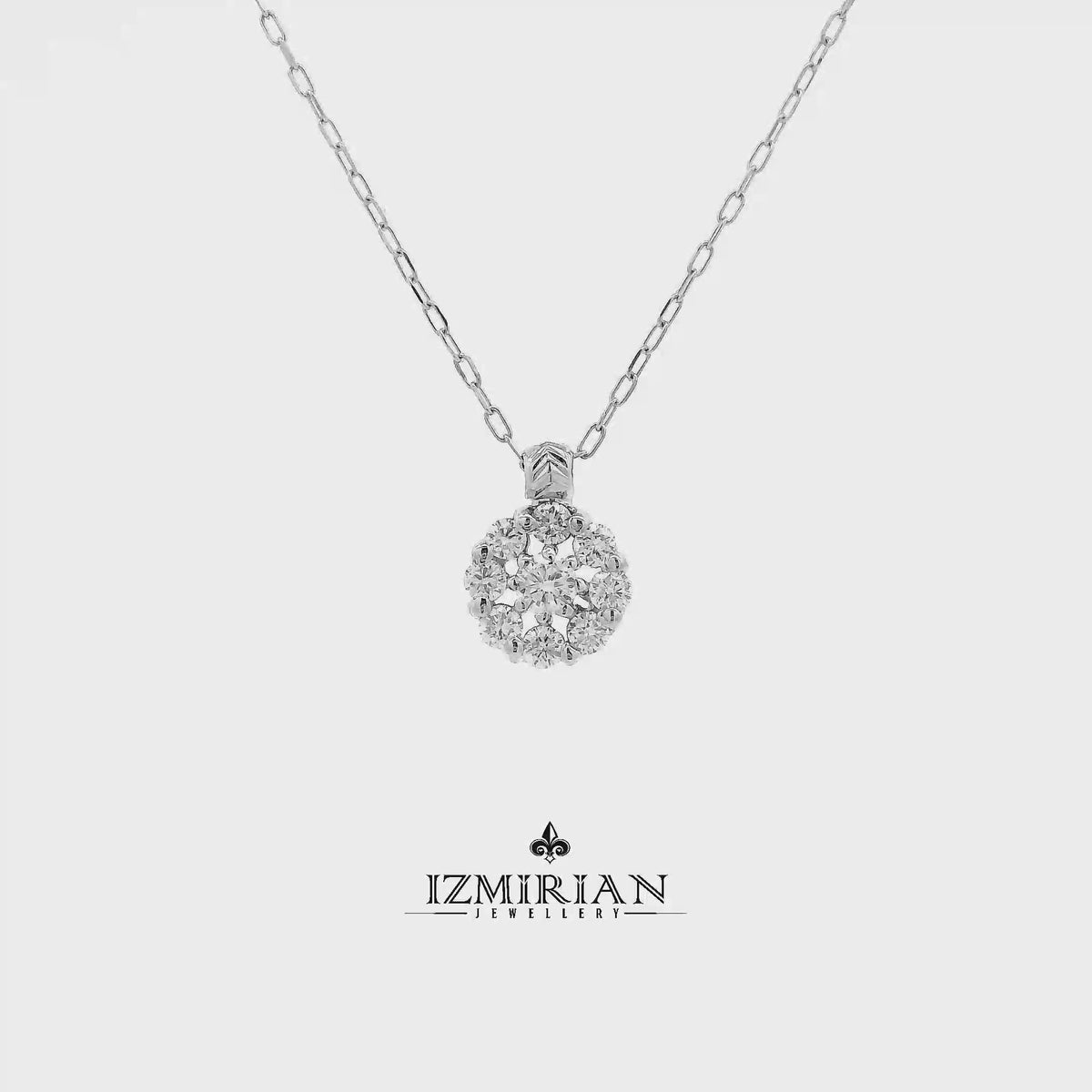 Diamond cluster pendant in white gold shown in motion