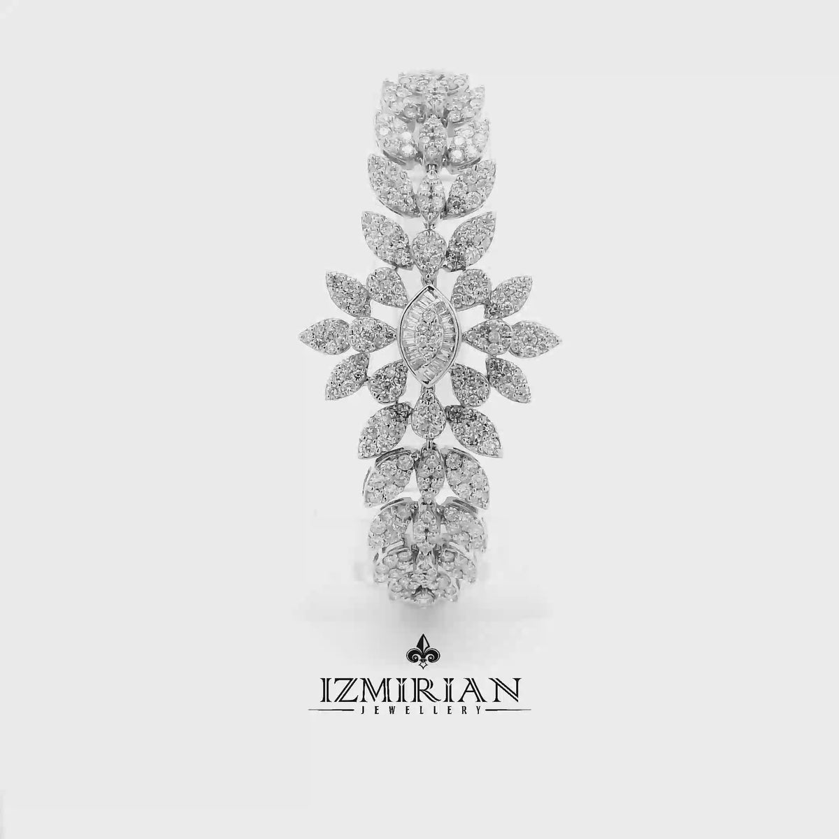 Diamond floral cascade drop earring in white gold shown in motion