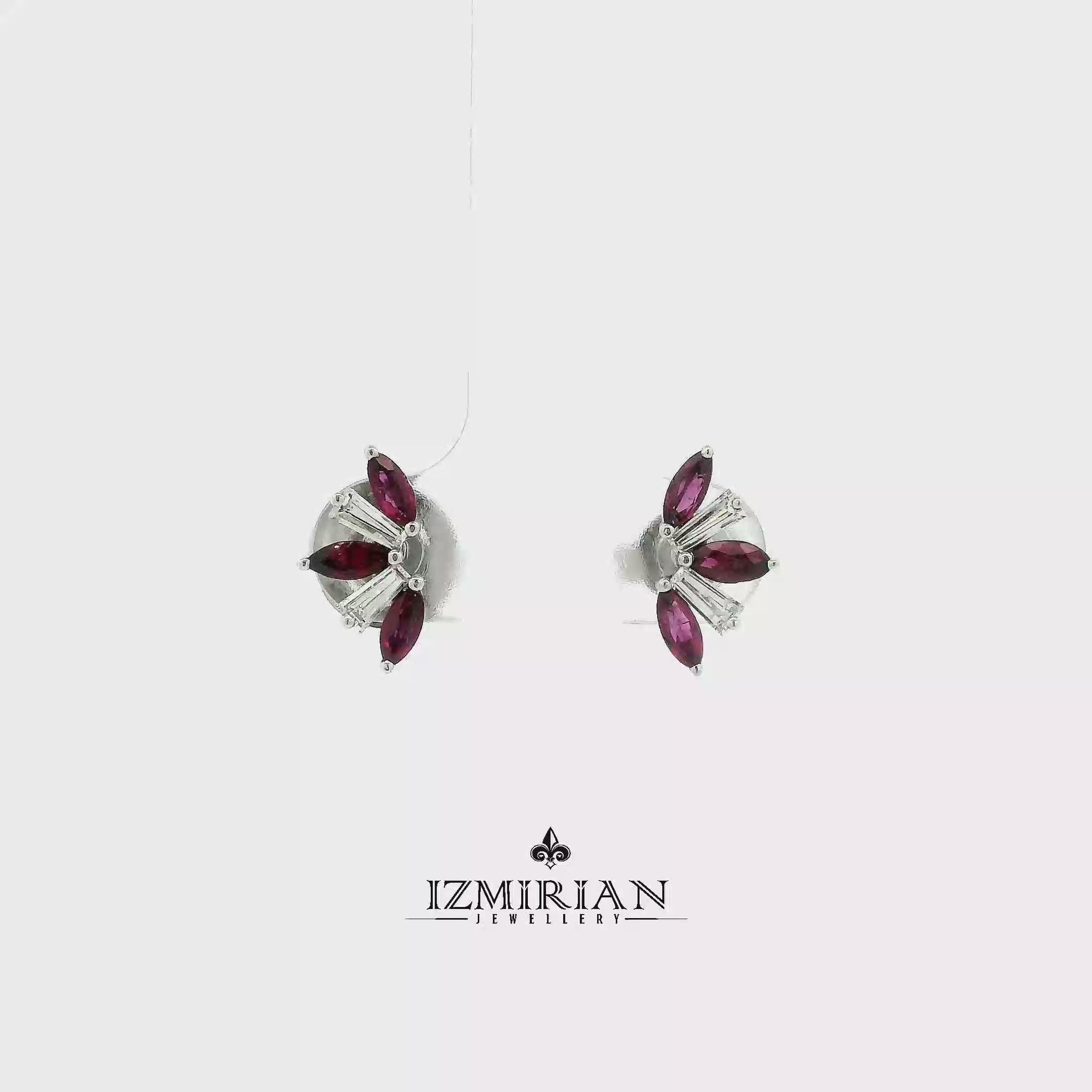 Ruby and baguette diamond stud earrings in white gold shown in motion