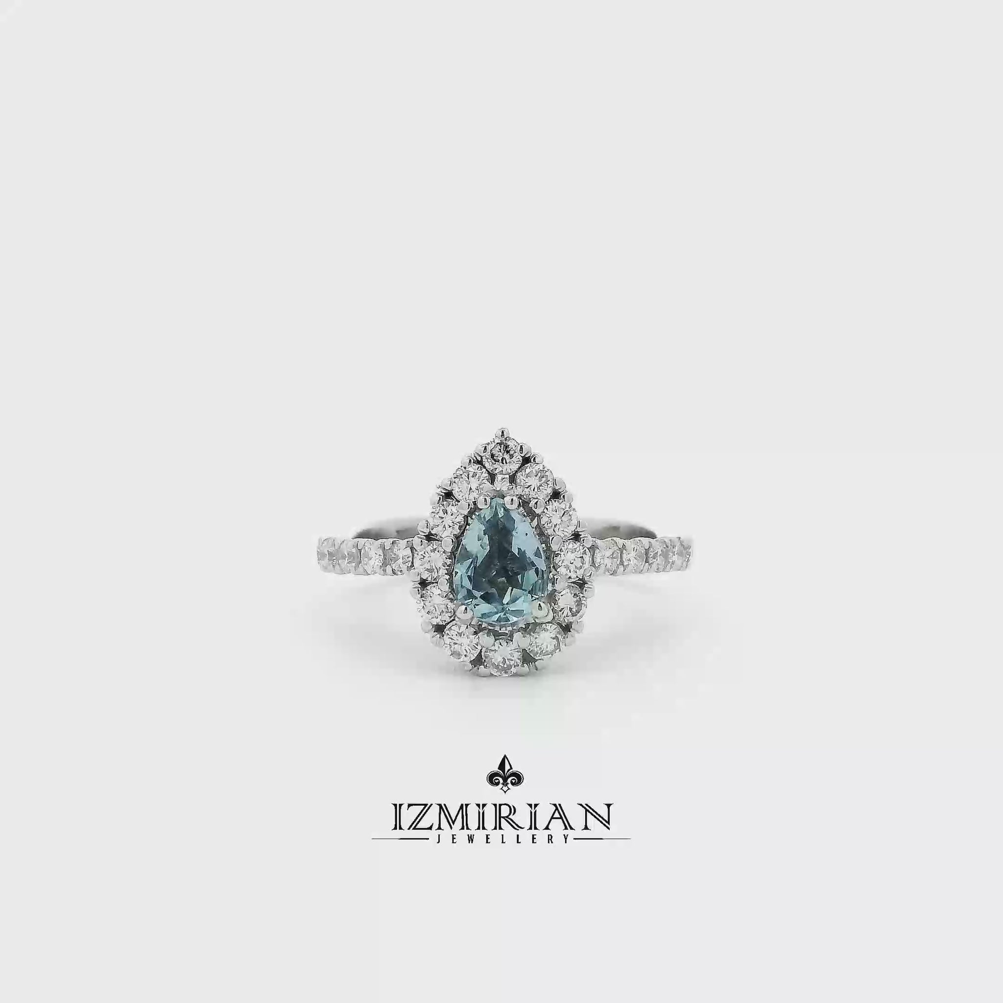 Pear-cut aquamarine halo ring in white gold shown in motion