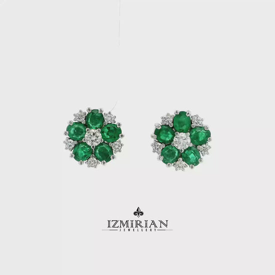 Emerald flower diamond stud earrings in white gold shown in motion