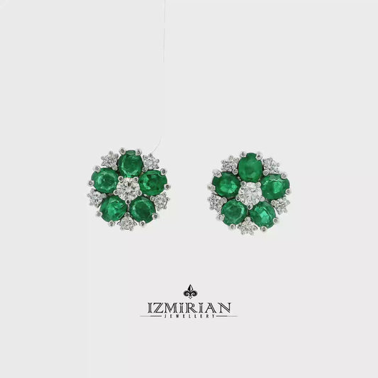 Emerald flower diamond stud earrings in white gold shown in motion