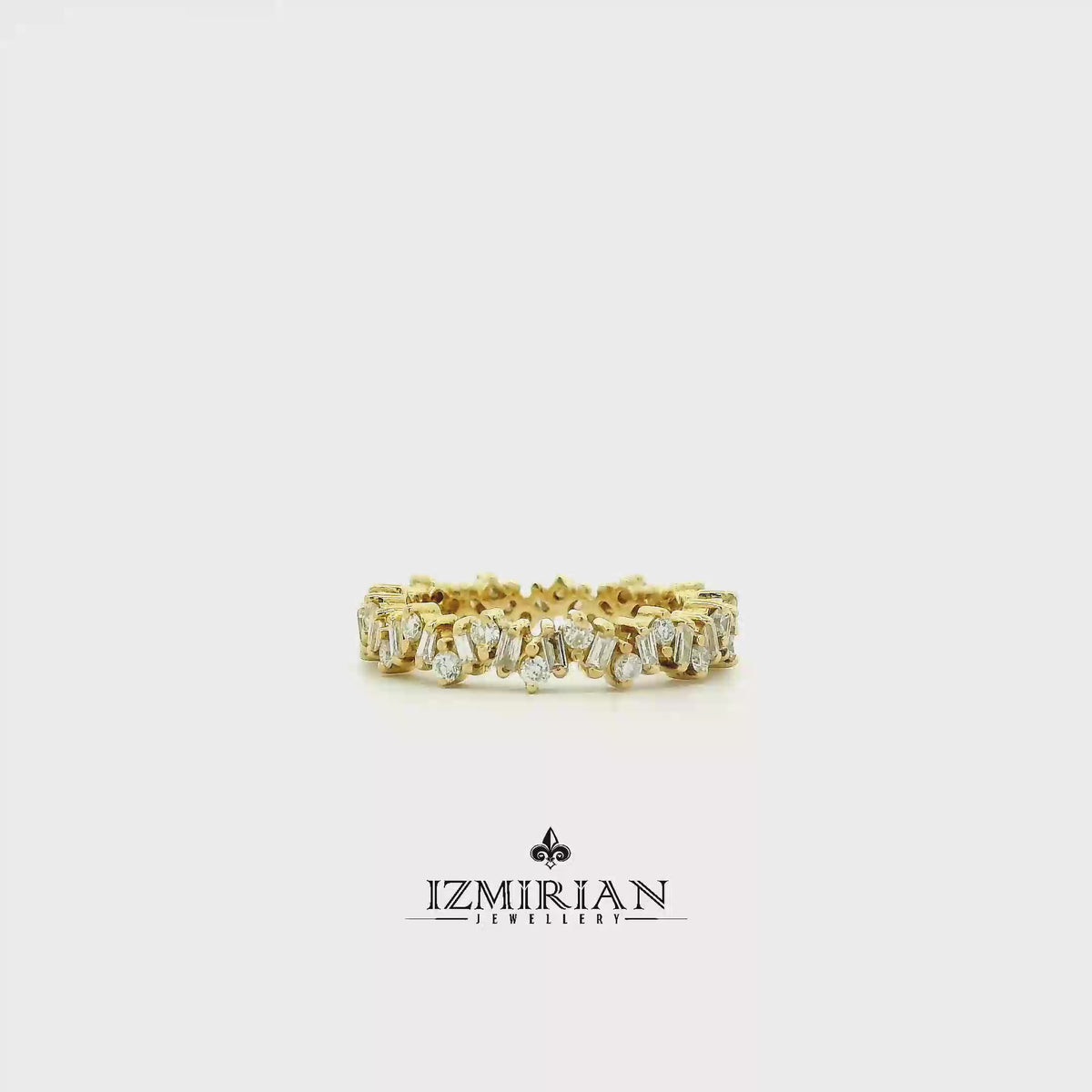 Baguette and round diamond band in yellow gold shown in motion