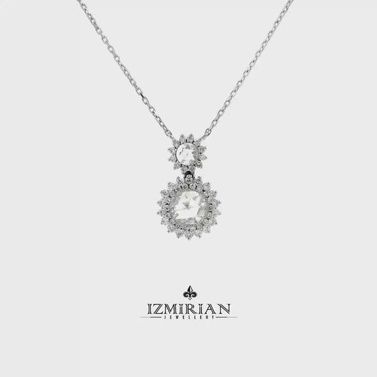 Double halo diamond drop pendant in white gold shown in motion
