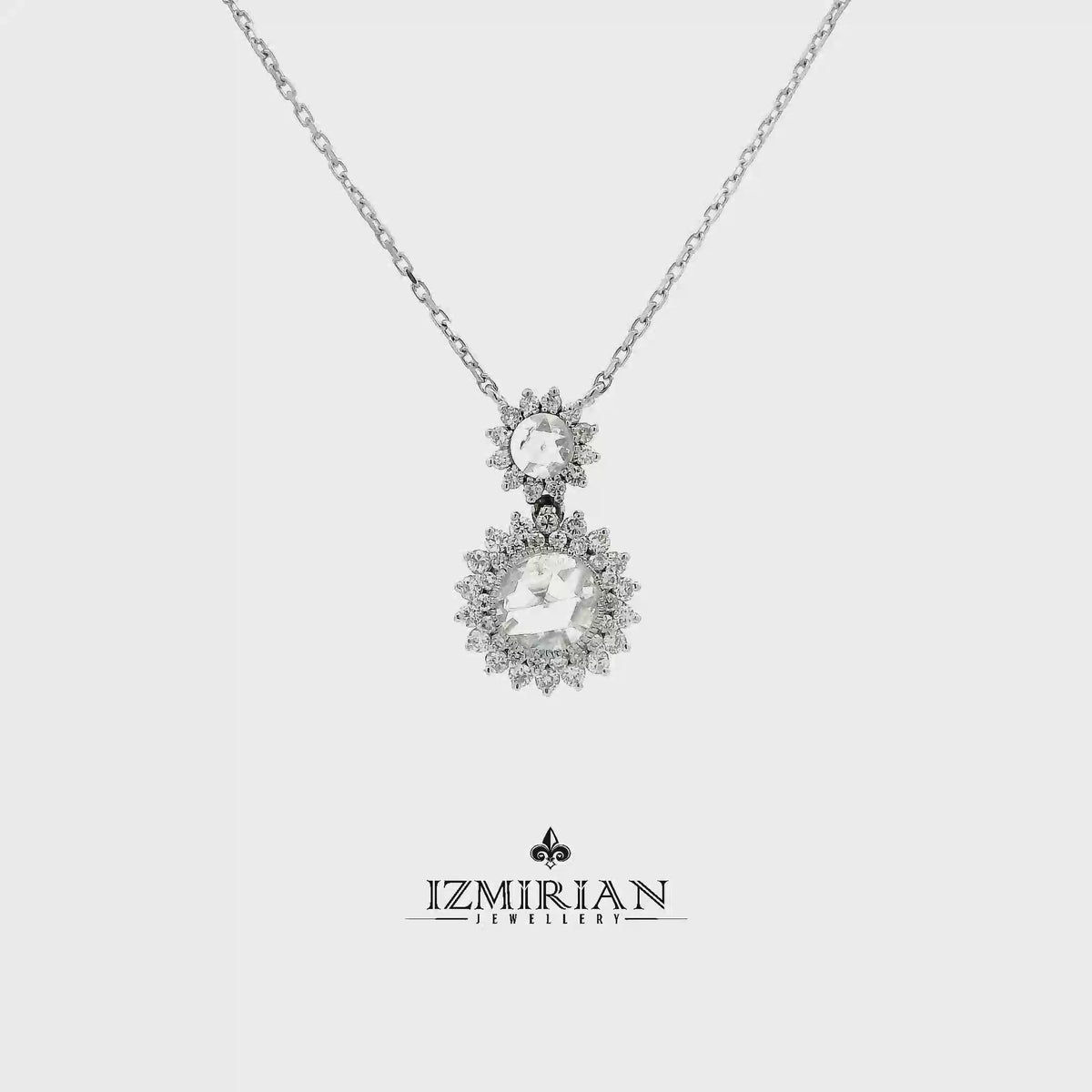 Double halo diamond drop pendant in white gold shown in motion