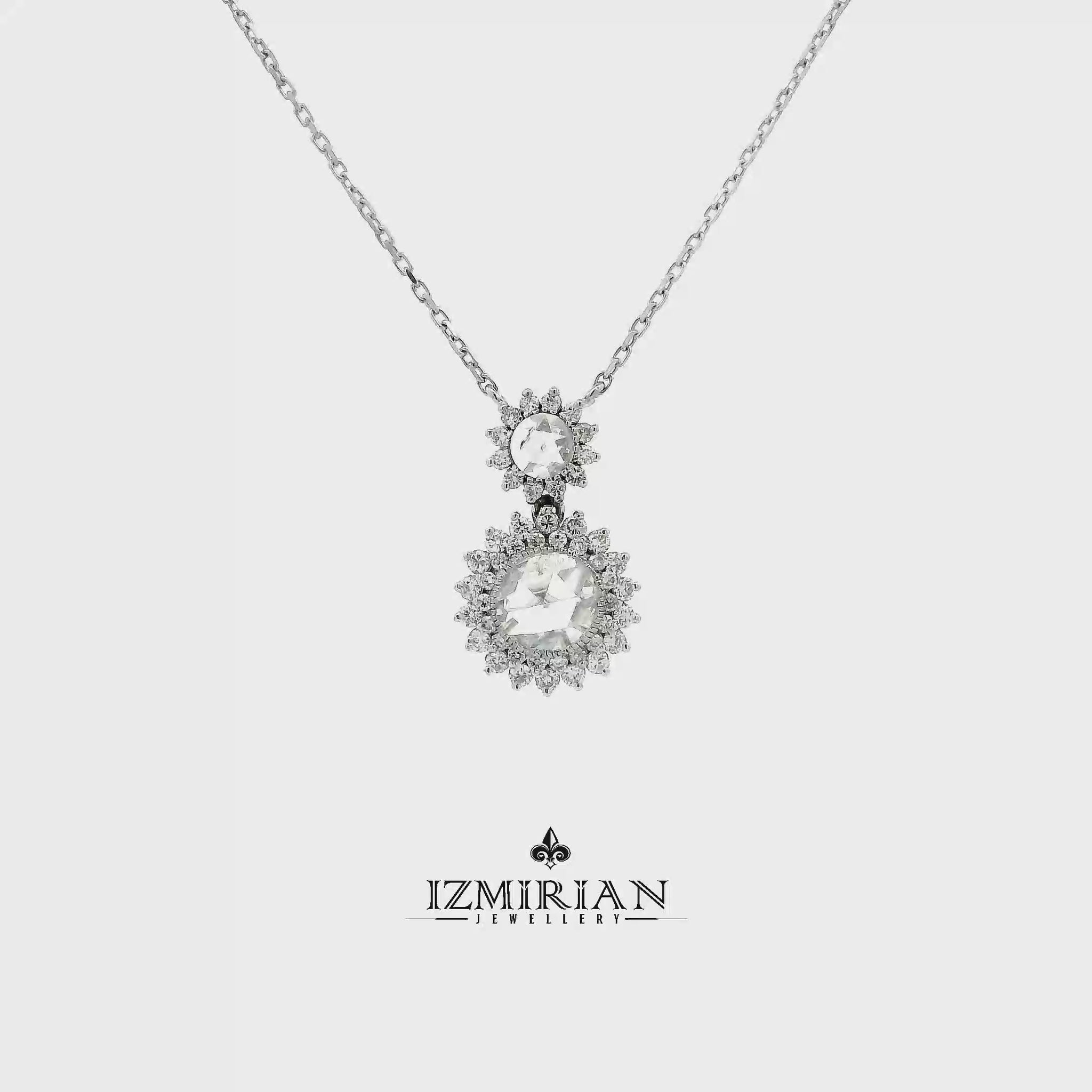 Double halo diamond drop pendant in white gold shown in motion