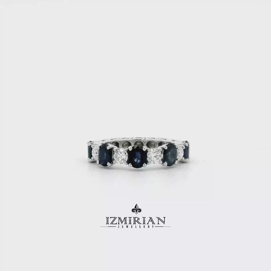 Blue sapphire and diamond eternity band in white gold shown in motion